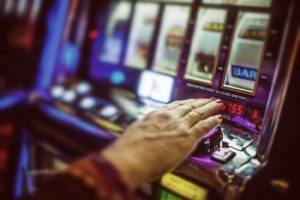 Woman's hand on a slot machine